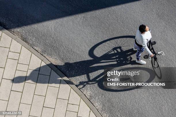 sporty and curvy women is waiting on the street in berlin - shadow people fitness stock pictures, royalty-free photos & images