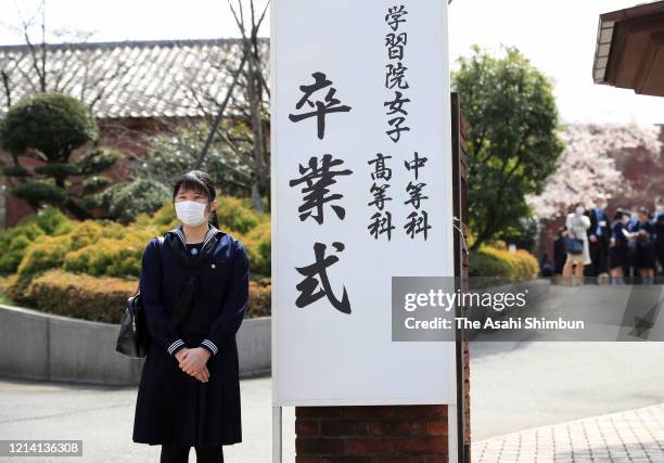 Princess Aiko, daughter of Emperor Naruhito, wearing a face mask amid the coronavirus outbreak, poses for photographs prior to the graduation...