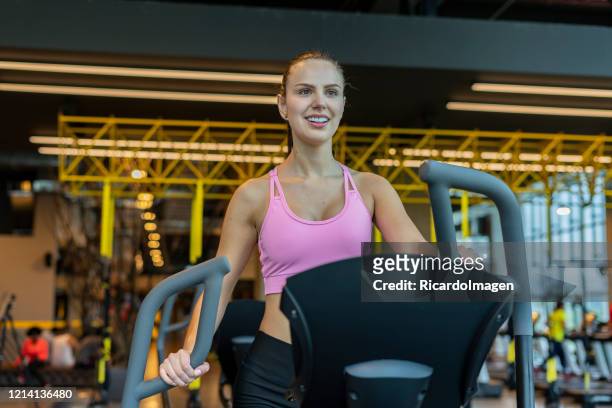 latin woman using dumbbell in the gym - hispanoamérica stock pictures, royalty-free photos & images
