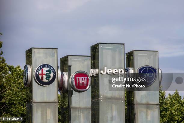 The logos of automobile companies Alfa Romeo, Fiat, Jeep, Lancia are pictured at the entrance to the Fiat Chrysler Automobiles at the Fiat Mirafiori...