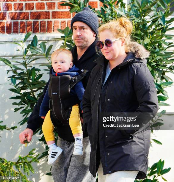 Amy Schumer and Chris Fischer take baby Gene Fischer out for some morning air on March 22, 2020 in New York City.