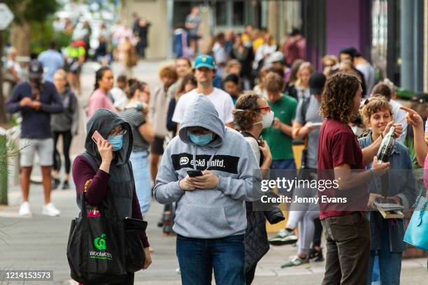 People are seen lining up at Centrelink in Bondi Junction on March 23, 2020 in Sydney, Australia. From midday Monday, venues such as bars, clubs,...