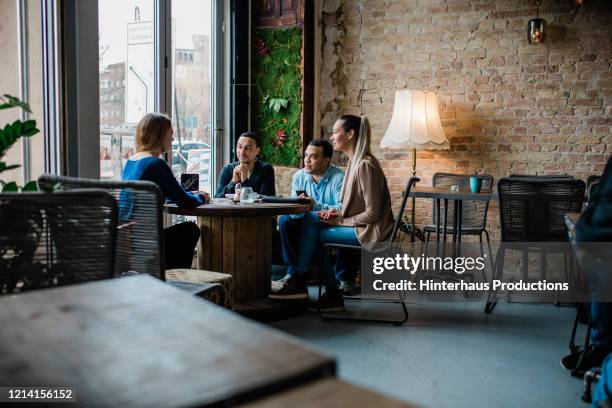 business colleagues talking during meeting at lunch - business meal stock pictures, royalty-free photos & images