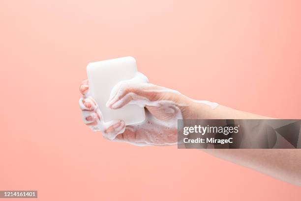 hand gripping a white soap - hygiene stock-fotos und bilder