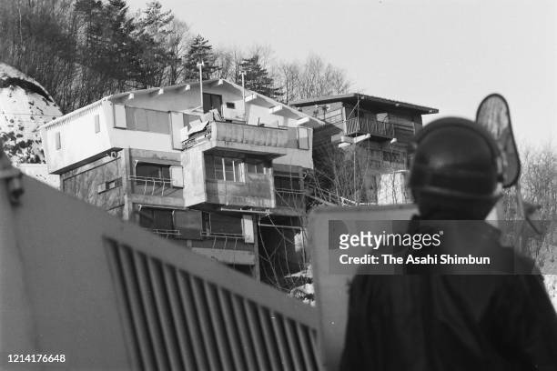 Riot police officers look up the Asama Sanso lodge, where the United Red Army members take a hostage on February 21, 1972 in Karuizawa, Nagano, Japan.