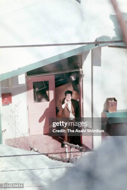 Bystander talks with riot police at the entrance of the Asama Sanso lodge, where the United Red Army members take a hostage, after sneaking through...