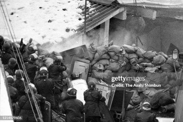 Police destroy the building with an iron ball and water cannon while riot police prepare for storming in as the United Red Army members take a...