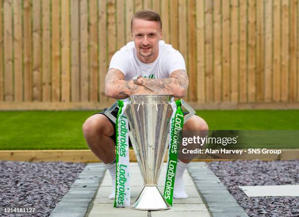 Leigh Griffiths is pictured with the Ladbrokes Premiership trophy which has been delivered to his house after Celtic are announced by the SPFL as...