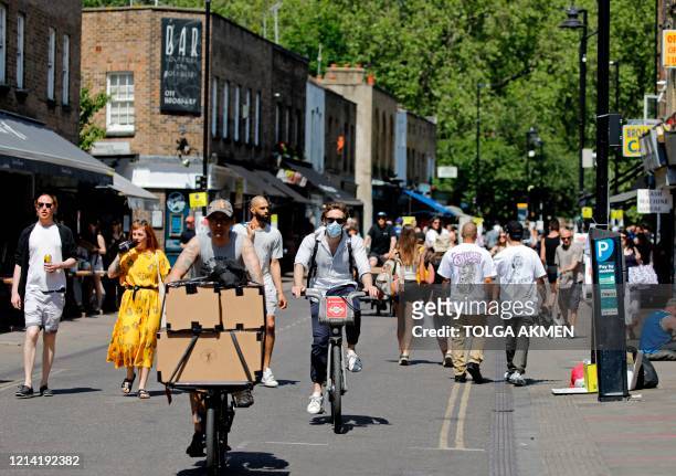 People get out in the sunshine in broadway market, Hackney, north east London on May 20 as temperatures in the capital are expected to reach 28C . -...