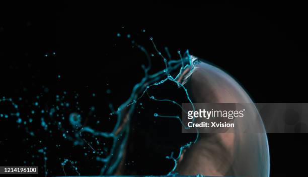 soap bubble broken moment shot by high speed sync. - spring flowing water stockfoto's en -beelden