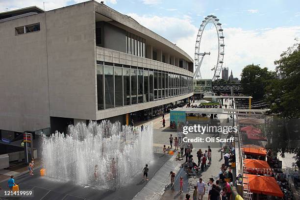 Children play in a fountain entitled 'Appearing Rooms' by artist Jeppe Hein at the Southbank Centre on August 19, 2011 in London, England. Members of...