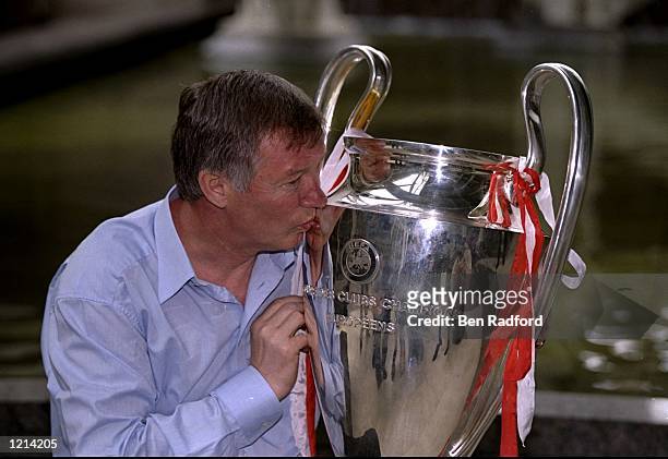 Manchester United manager Alex Ferguson kisses the European Cup on his return to Manchester after victory in the UEFA Champions League final over...