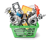 Car spares parts in market basket isolated on white background