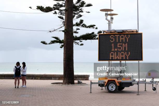 Sign reminding residents and tourists of new social distancing rules is displayed at Manly Beach on March 23, 2020 in Sydney, Australia. From midday...