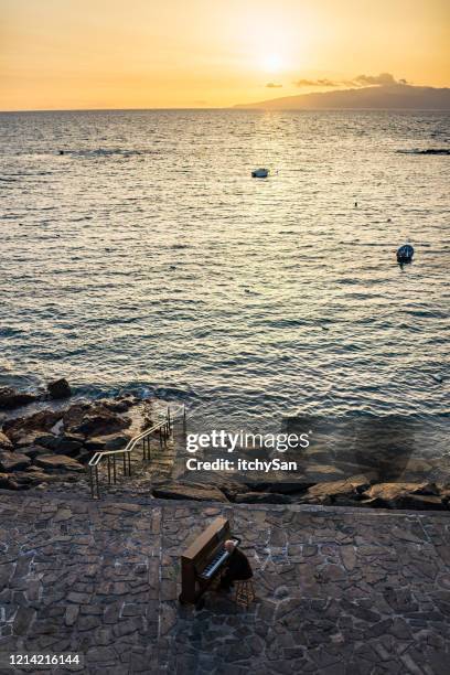 playing a piano in front of the ocean - pianist front stock pictures, royalty-free photos & images