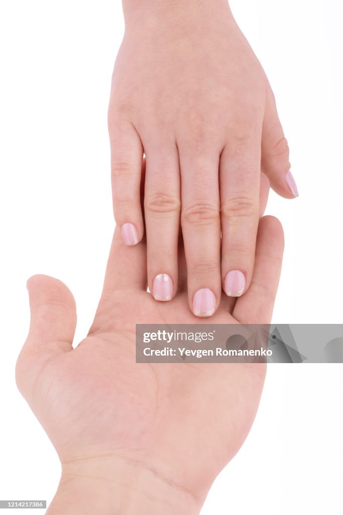 Male hand holds a female hand isolated on a white background