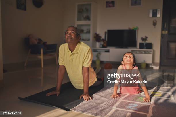 grandfather and granddaughter doing yoga - child yoga elevated view stock pictures, royalty-free photos & images