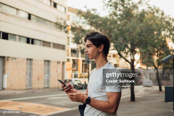 young male using phone - long weekend australia stock pictures, royalty-free photos & images