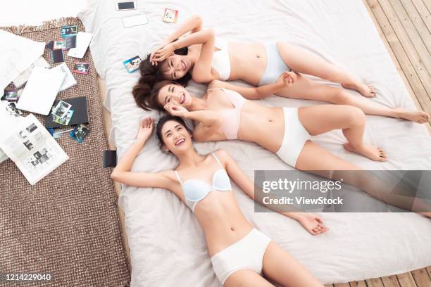 girlfriends lay in bed to play together - seize the day bed private view stock pictures, royalty-free photos & images