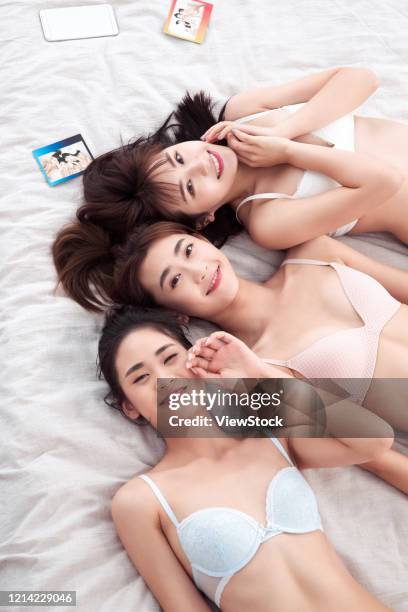 girlfriends lay in bed to play together - seize the day bed private view stock pictures, royalty-free photos & images