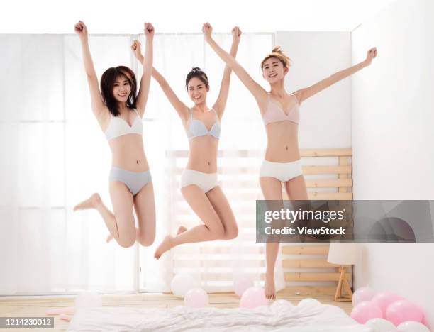 girlfriends play jumping in the bedroom - seize the day bed private view stock pictures, royalty-free photos & images