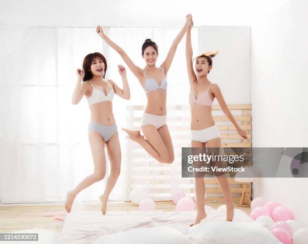 girlfriends play jumping in the bedroom - seize the day bed private view stock pictures, royalty-free photos & images