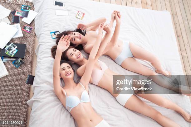 girlfriends lay in bed to play together - seize the day bed private view stock pictures, royalty-free photos & images