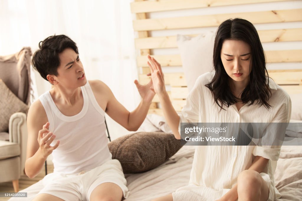 Young lovers quarrel on the bed