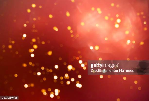 red abstract blurred bokeh lights background. christmas, valentine's day, birthday holiday concept - gold meets golden fotografías e imágenes de stock