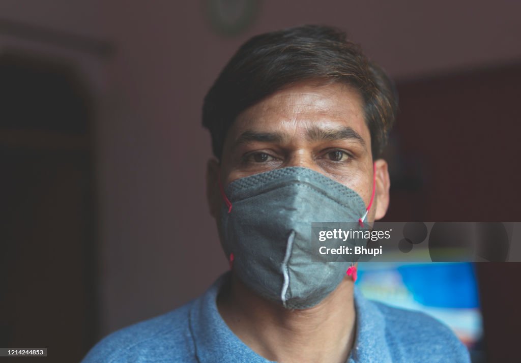 The sad man is protecting herself and wearing a mask against the corona virus