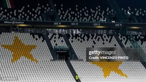 Stewart stands in an empty tribune of the Allianz Juventus stadium on March 8, 2020 in Turin during the Italian Serie A football Match Juventus vs...