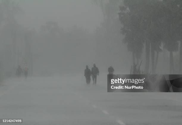 Residents walk along a street to a shelter ahead of the expected landfall of cyclone Amphan in Dhamra area of Bhadrak district, 160 km away from the...