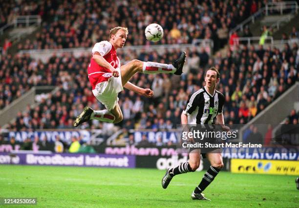 Dennis Bergkamp of Arsenal controls the ball as Andrew O'Brien of Newcastle looks on during the Premier League match between Newcastle United and...