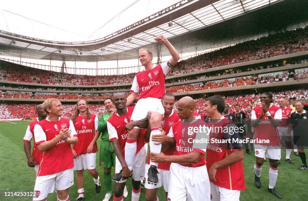 Dennis Bergkamp is chaired by his former teammates Patrick Vieira and Thierry Henry after the Dennis Bergkamp Testimonial between Arsenal XI and Ajax...