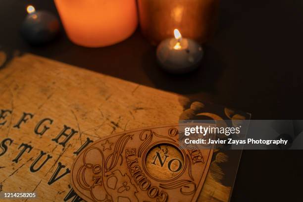 ouija board on dark background - séance photo stock pictures, royalty-free photos & images