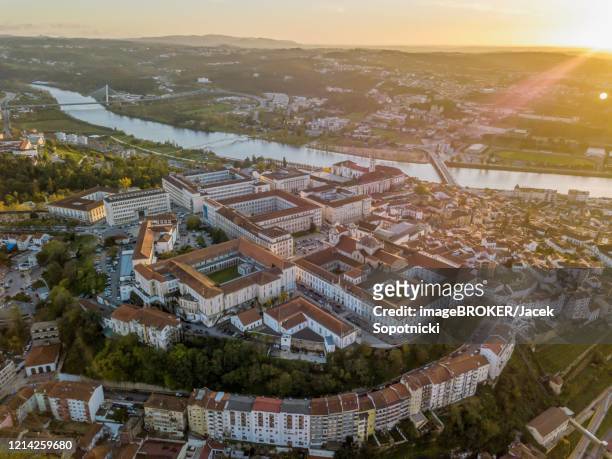 aerial view of coimbra with university at top of the hill at sunset, portugal - coimbra university foto e immagini stock