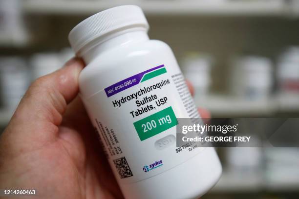 Pharmacy tech holds a bottle of Hydroxychloroquine at Rock Canyon Pharmacy in Provo, Utah, on May 20, 2020. - US President Donald Trump announced May...