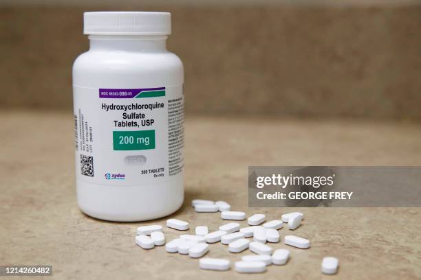 Bottle and pills of Hydroxychloroquine sit on a counter at Rock Canyon Pharmacy in Provo, Utah, on May 20, 2020. - US President Donald Trump...