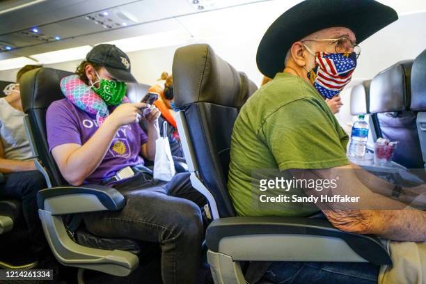 Passengers onboard an American Airlines flight to Charlotte, NC at San Diego International Airport on May 20, 2020 in San Diego, California. Air...