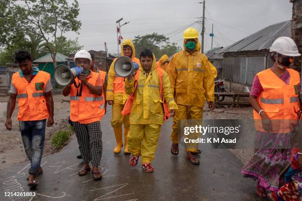 Volunteers of Cyclone Preparedness Program walk use a megaphone to urge residents to evacuate to shelters ahead of the expected landfall of cyclone...