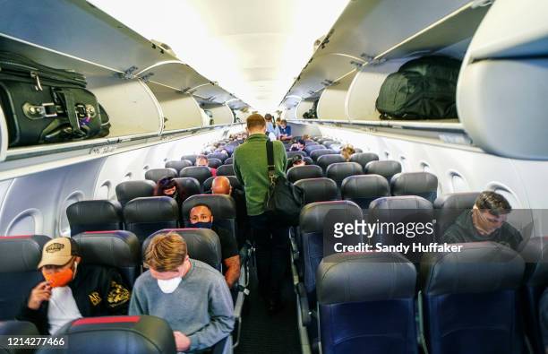 Passengers board an American Airlines flight to Charlotte, North Carolina at San Diego International Airport on May 20, 2020 in San Diego,...