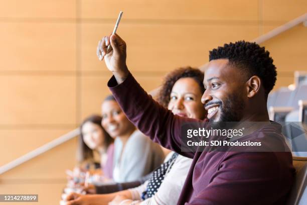 african american student raises his hand during class - student asking stock pictures, royalty-free photos & images