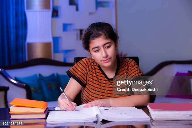 teenager girl doing her homework stock photo - school book stock pictures, royalty-free photos & images