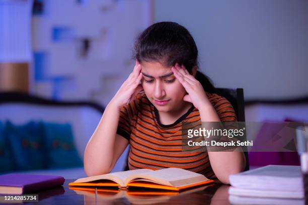 teenager girl doing her homework stock photo - stressed student stock pictures, royalty-free photos & images
