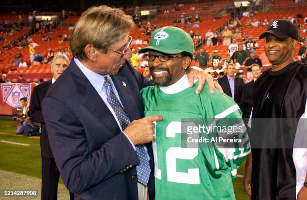 Spike Lee, wearing a New York Jets Joe Namath No. 12 jersey, meets with former New YOrk Jets player and Hall of Famer Joe Namath on the sidelines...