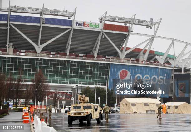 Tents, vehicles and other equipment from the Maryland National Guard occupy a section of parking lot on the south side of FedEX Field that officials...