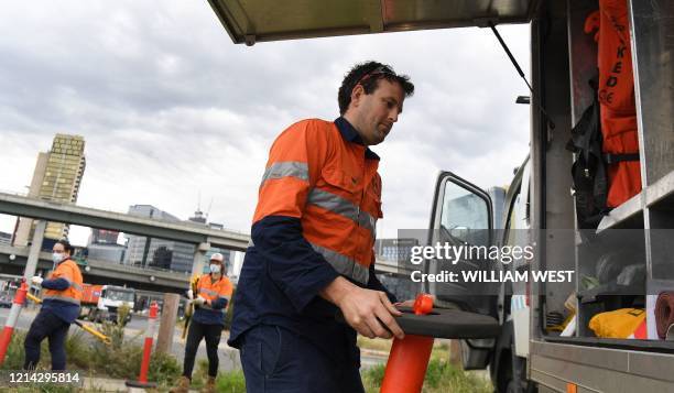 This photo taken on May 19, 2020 shows hydrographer Steven Paull and trainee hydrographers Andrew Lamb and Kingsley Moss taking samples from a sewer...