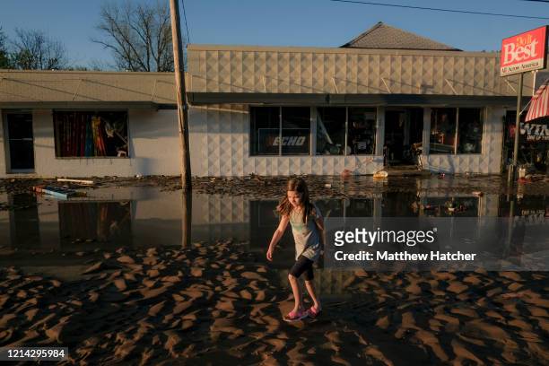As record floodwaters begin to recede, local residents walk the ruined streets to see the extent of damage following extreme flooding throughout...