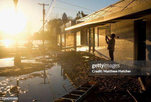 As record floodwaters begin to recede, local residents walk the ruined streets to see the extent of damage following extreme flooding throughout...