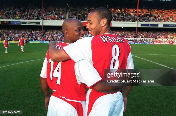 Ian Wright and Thierry Henry of Arsenal exchange shirts before the Martin Keown Testimonial between Arsenal and World XI on May 17, 2004 at Arsenal...